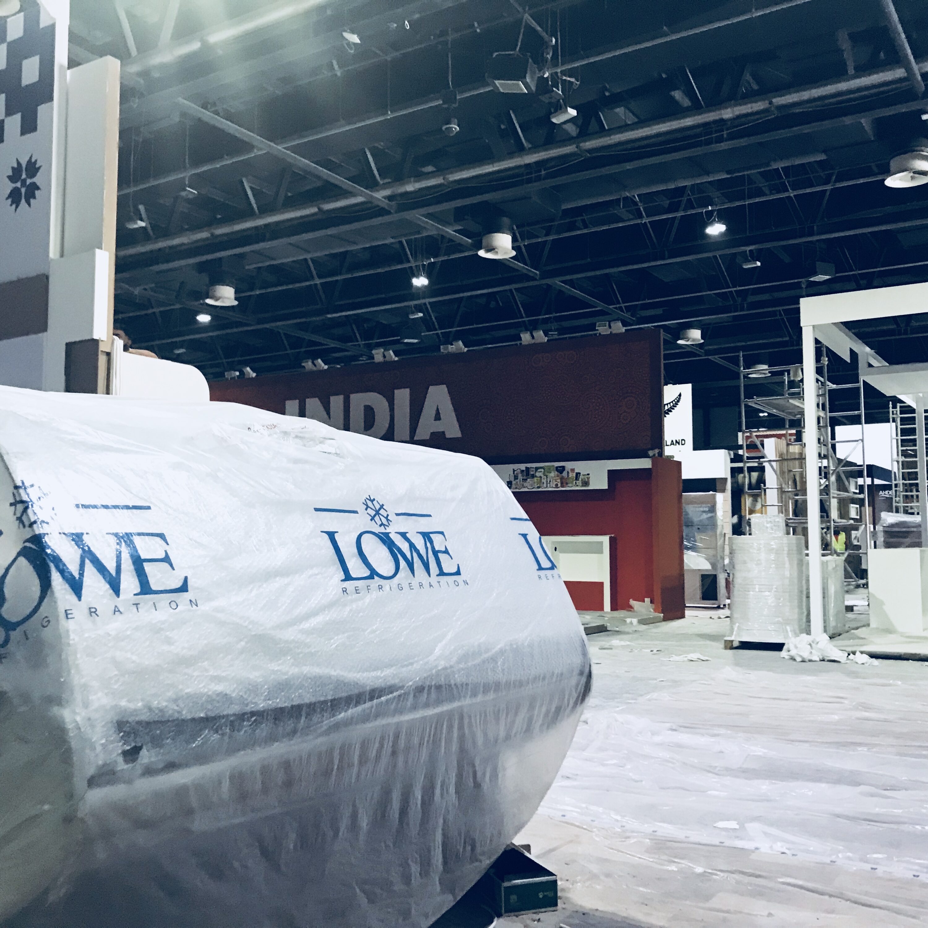 White packaging with blue branding in a spacious exhibition hall at Gulfood 2018.