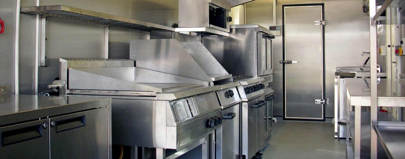Stainless steel kitchen equipment arranged in a modern, functional layout, showcasing a clean, industrial design.