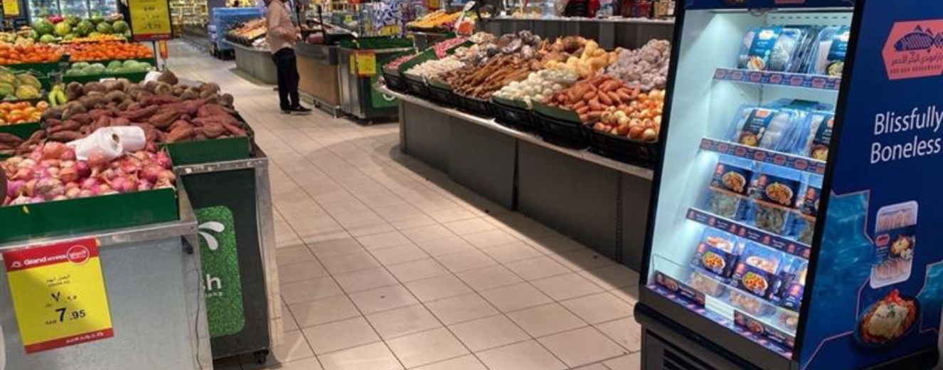 Vibrant display of fresh produce, including fruits and vegetables, in a retail environment.
