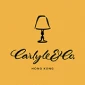 Carlyle & Co. logo on a vibrant yellow background featuring a lamp silhouette.