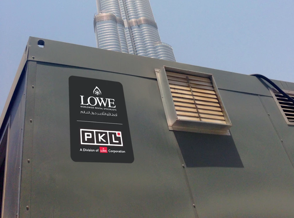 Lowe and PKL logos on a grey temporary kitchen unit with metal ventilation pipes in background.
