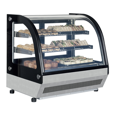 Refrigerated countertop display fridge with glass front, showcasing assorted pastries on black and silver shelves.