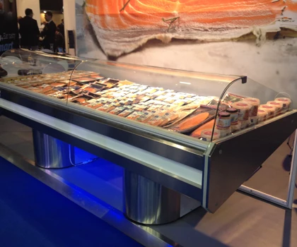 Display of various seafood products in a chilled showcase, featuring silver and blue tones.