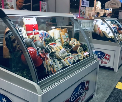 Display of assorted ice cream products in a glass-front freezer, featuring vibrant packaging and colours.