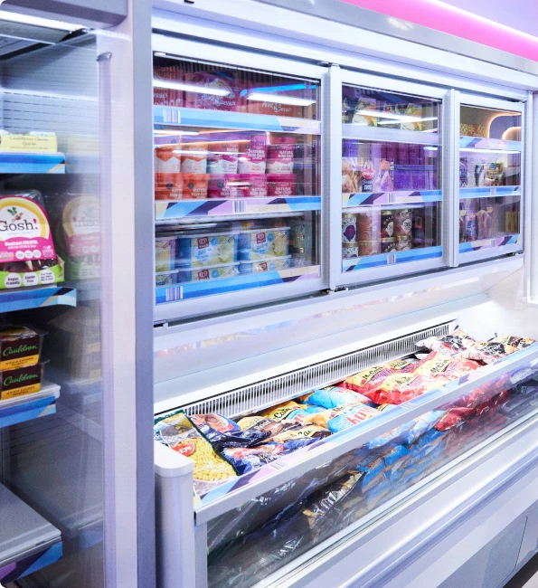 Brightly lit freezer section displaying various frozen food products in colourful packaging.