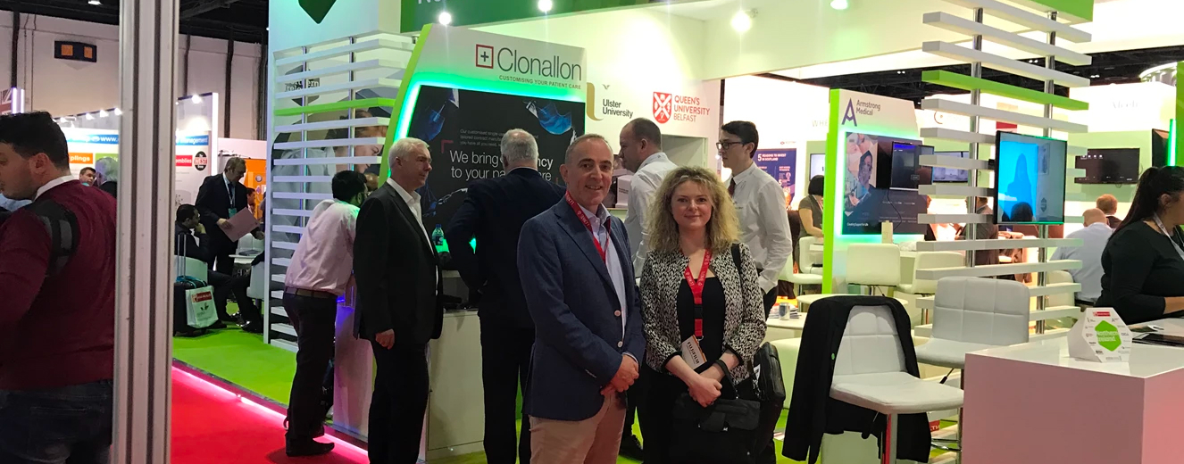 Team Lowe poses in front of a green and black exhibition stand at Arab Health 2018.