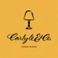 Carlyle & Co. logo on a vibrant yellow background featuring a lamp illustration.