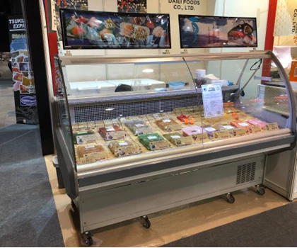 Chilled display cabinet filled with various food items, featuring a sleek silver finish and vibrant packaging.