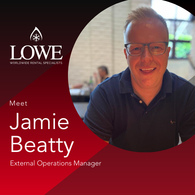 Jamie Beatty, External Operations Manager, smiles in a navy polo against a red and white background.
