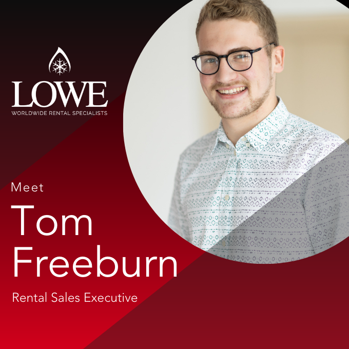 Tom Freeburn, a Rental Sales Executive, smiles in a patterned shirt against a red and grey background.