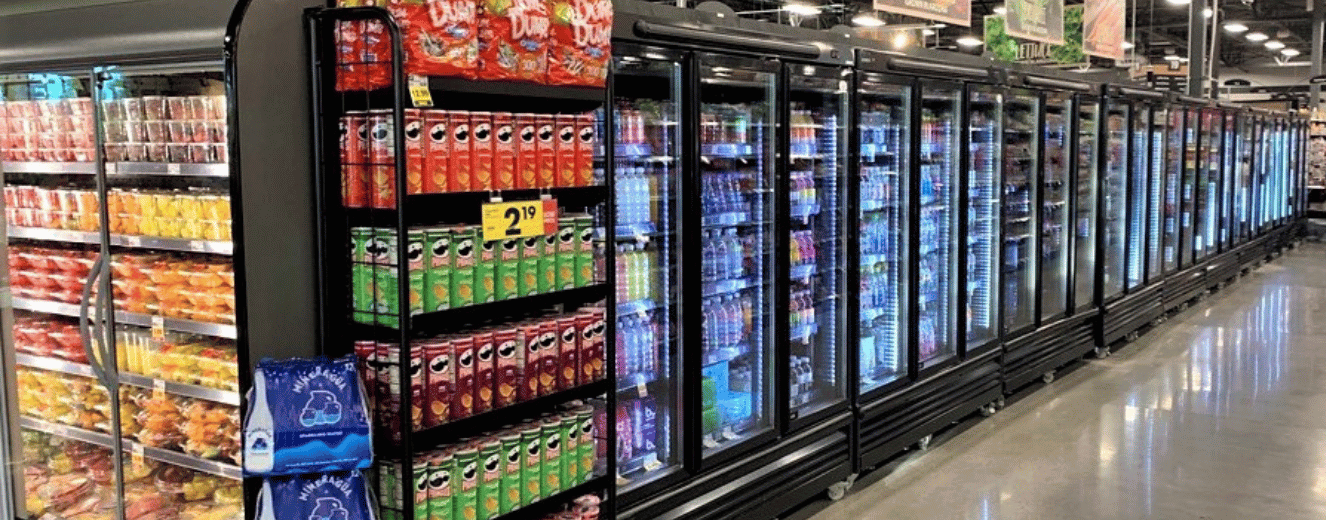 Refrigeration units displaying various beverages, with bright packaging in red and green hues.