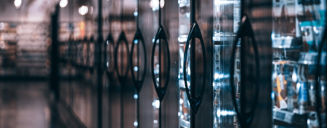 Black handles of refrigeration units with a sleek, reflective surface in a modern setting.