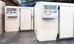 Mobile walk-in cold room with white walls and grey flooring, featuring air conditioning units.