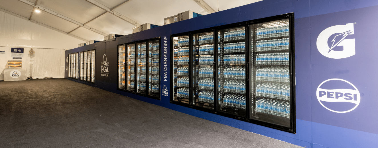 Refrigerated display units filled with bottled water, set against a blue backdrop at a PGA event.