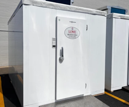 White cold storage unit with a circular "Lime Restaurant" sign on the door.