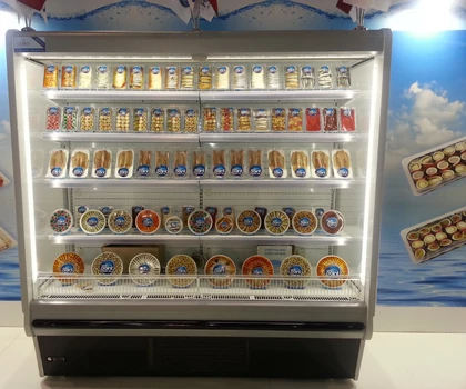 A refrigerated display showcasing various packaged food items, predominantly featuring vibrant colours and clear labels.