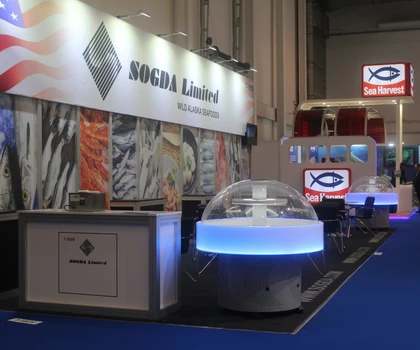 SOGDA Limited exhibition stand featuring a circular display with blue lighting and colourful background graphics.