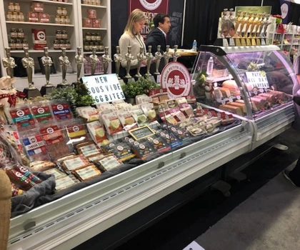 A display of assorted food products, featuring colourful packaging and a glass-fronted showcase.