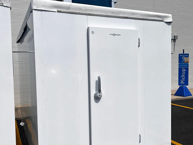 White storage unit with a lock, set against a light-coloured wall and blue accents.