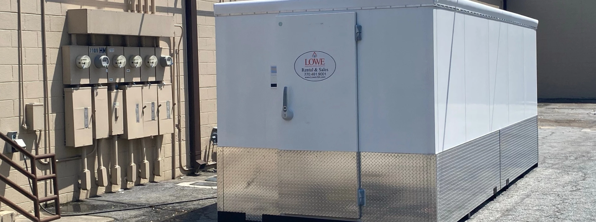 White food storage unit with a silver base, featuring a red and blue logo on the front.