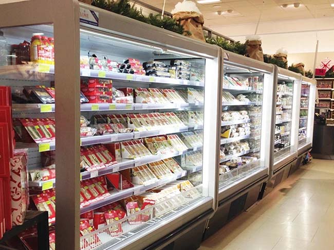 A well-stocked fridge displaying various packaged food items in bright, clear plastic containers.